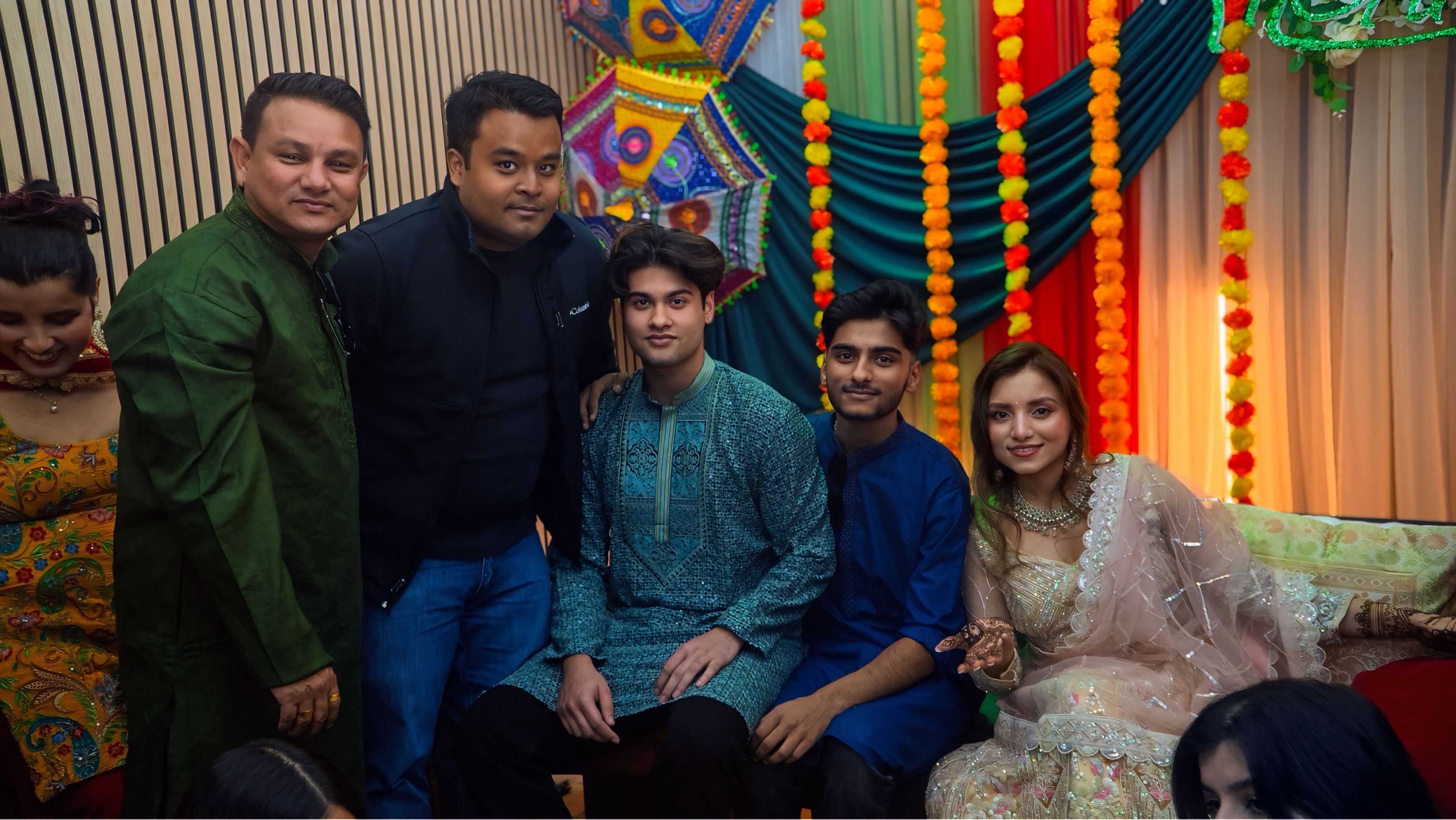 Candid group photo at mehndi ceremony with guests in traditional attire